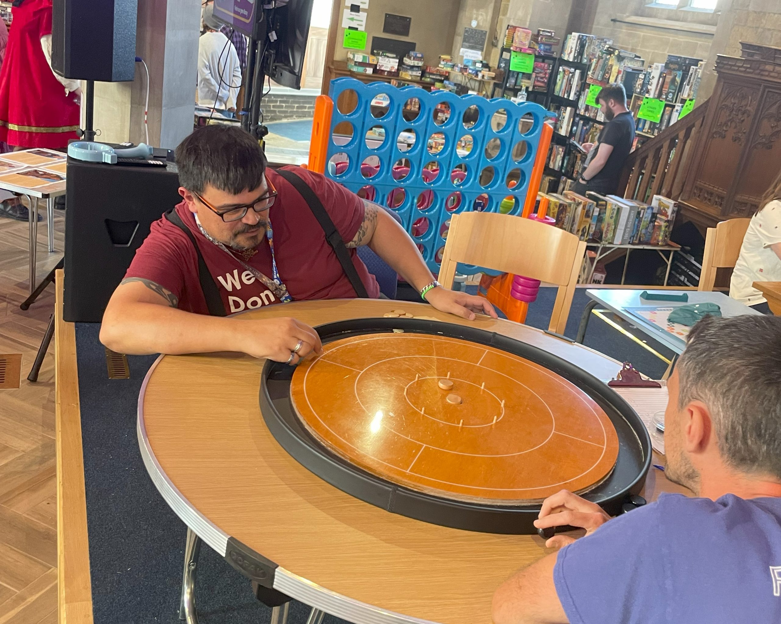 Gavin Price taking part in the Crokinole tournament
